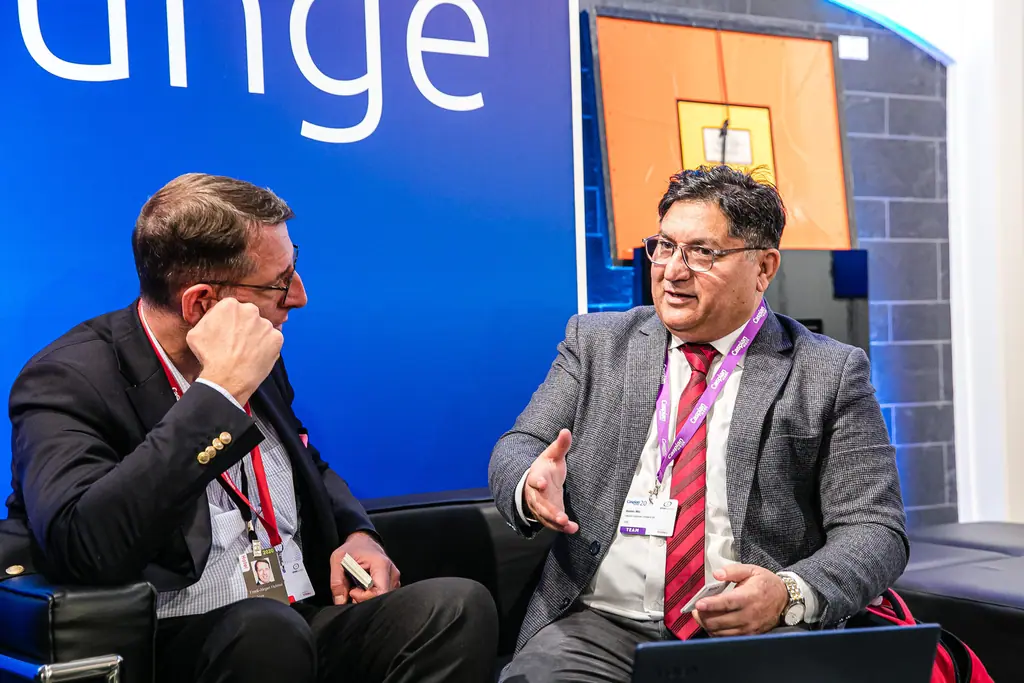 Two men in conversation on a sofa in the Caspian Lounge